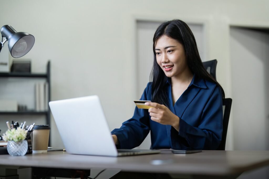 Woman on desk with laptop, credit card and ecommerce payment for online shopping at home. digital