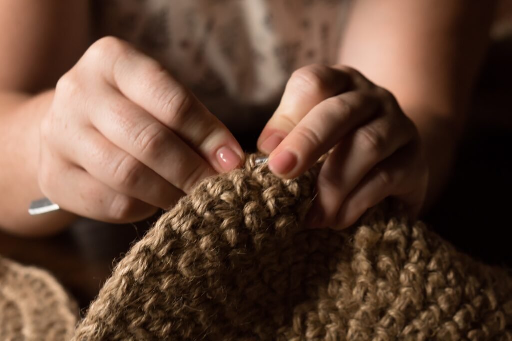 Craftswoman crocheting from jute